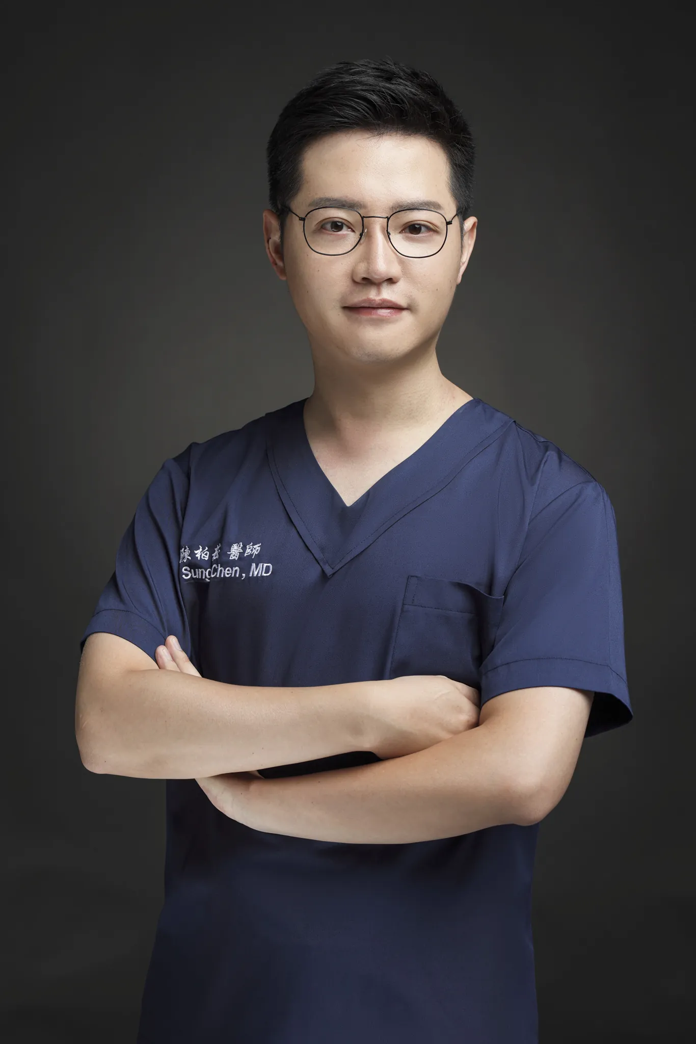 陳柏菘醫師穿著深藍色手術服的正式形象照